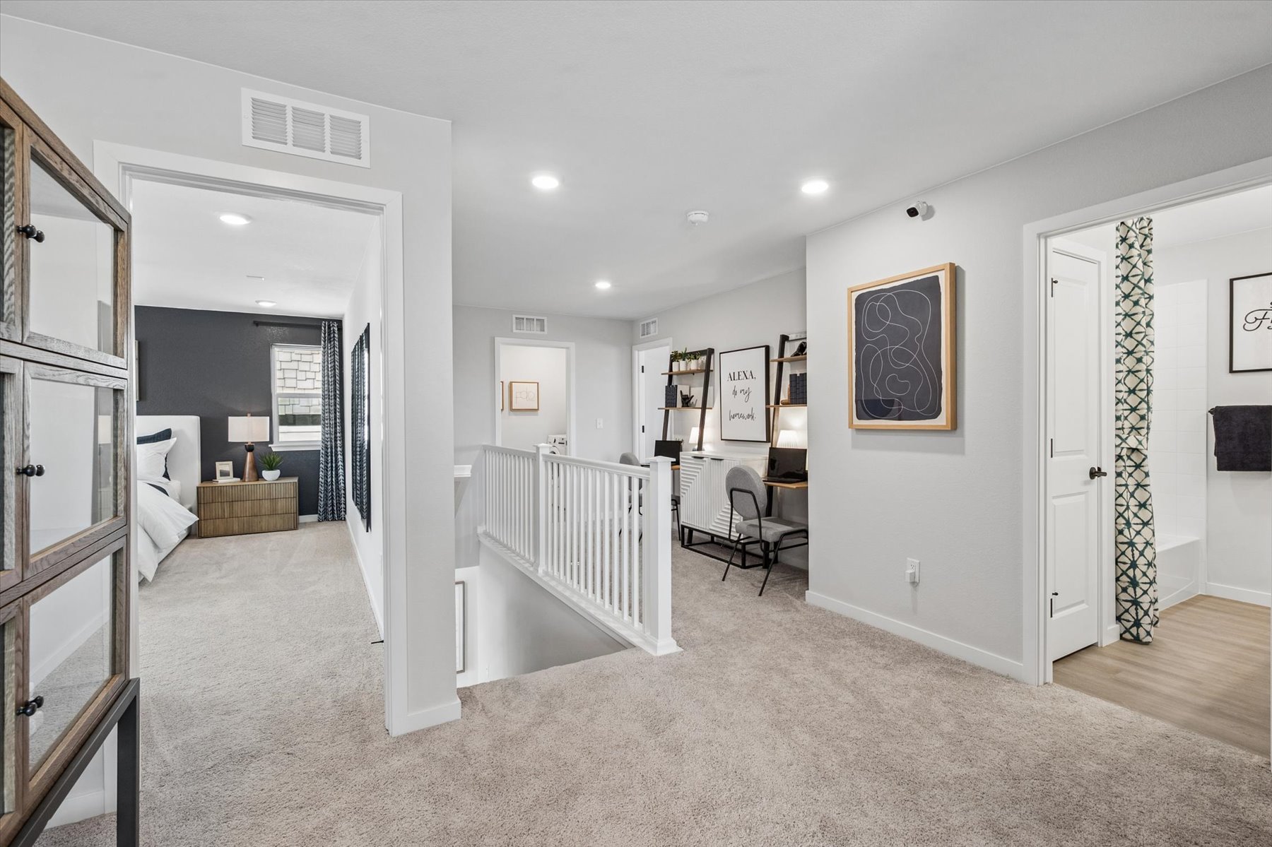 A large room with a bed and a white railing.