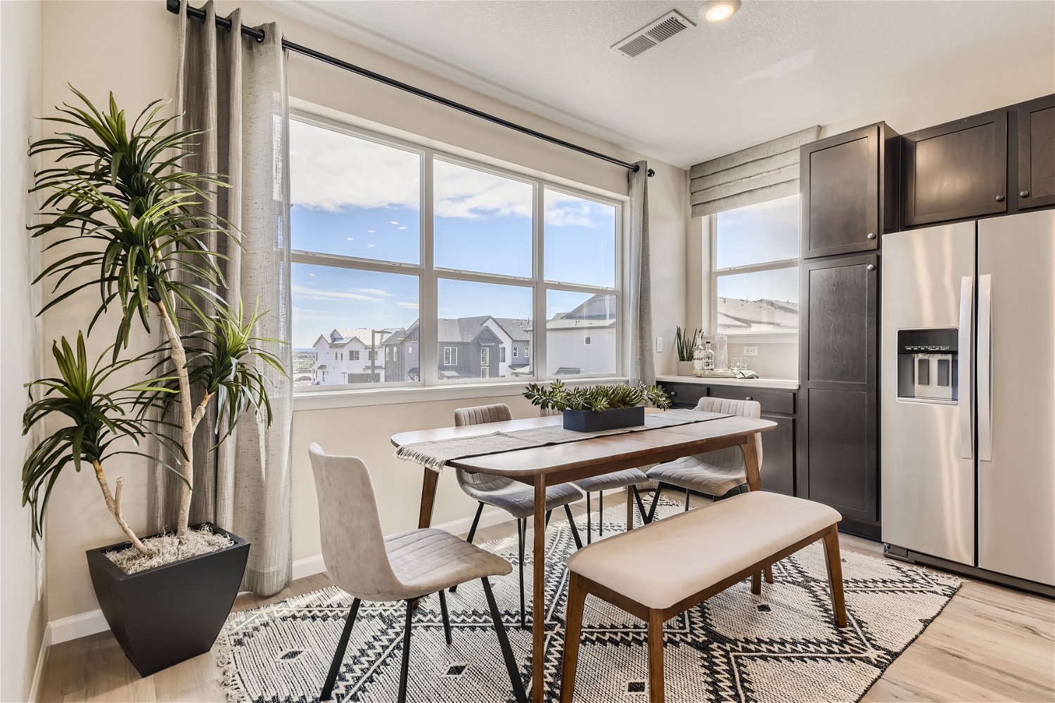 A kitchen with a table and chairs.