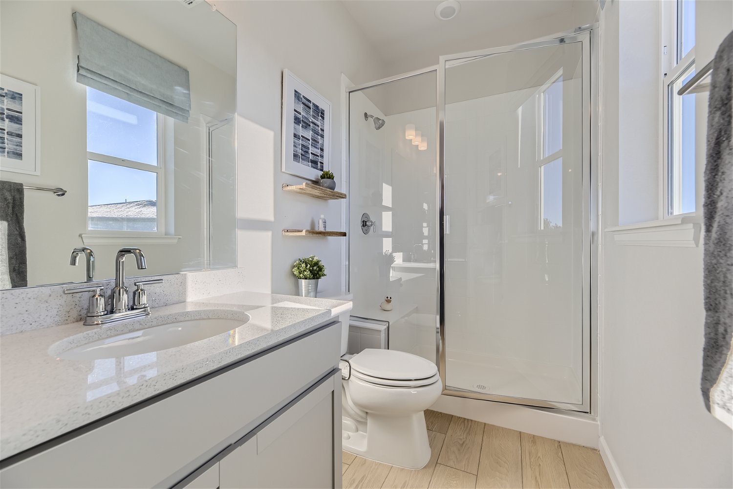 A bathroom with a sink toilet and shower.