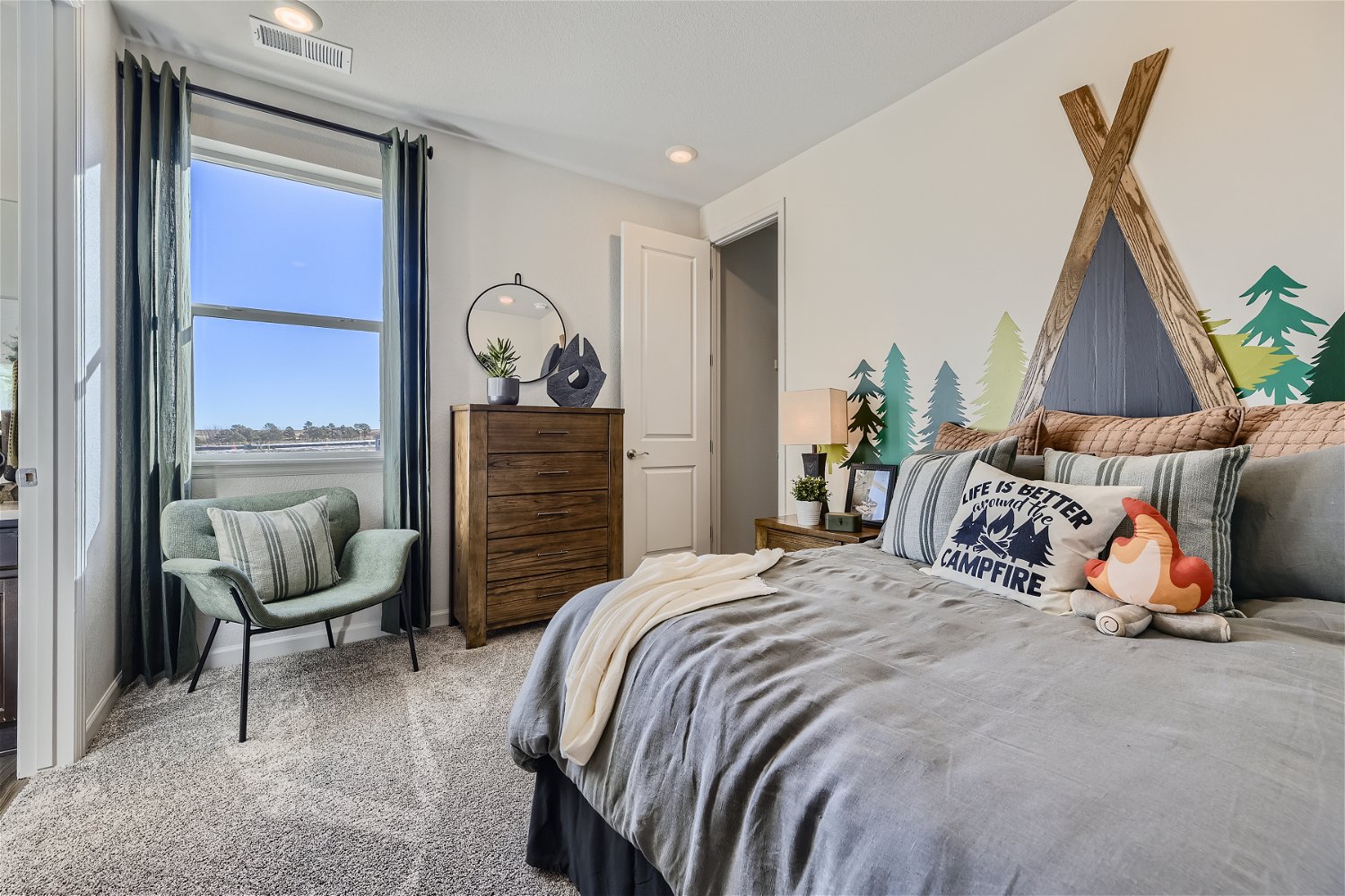 A bedroom with a bed and a chair.