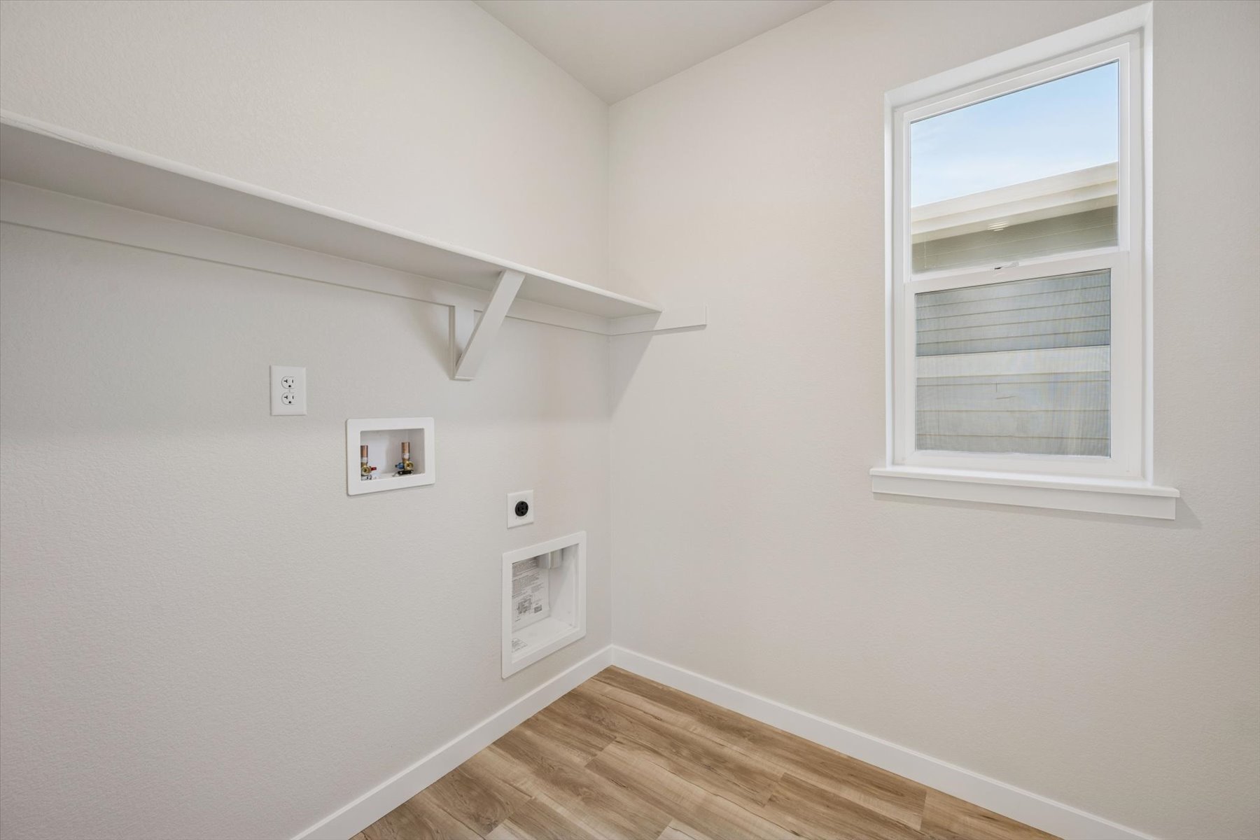 A room with a wood floor and white walls.