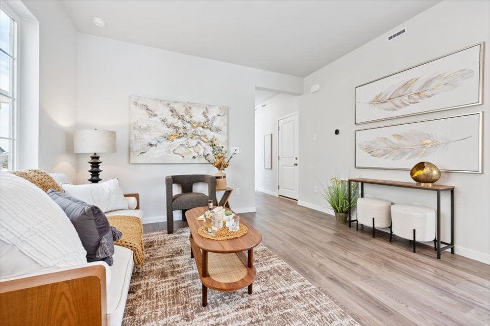A living room with a wood floor.