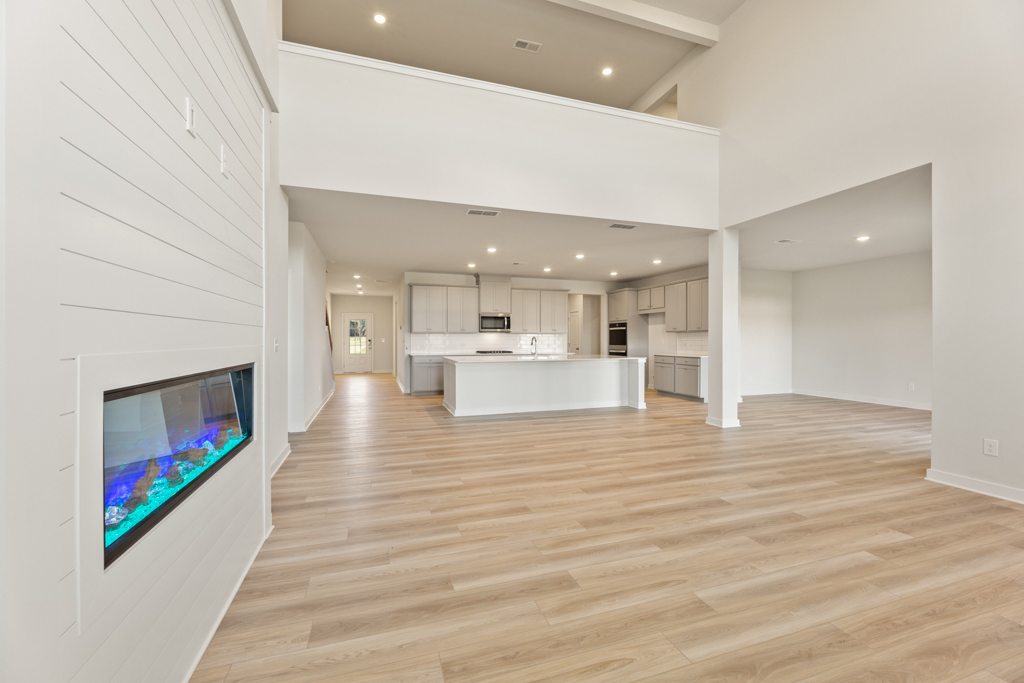 A large white room with a large television and a large white wall.