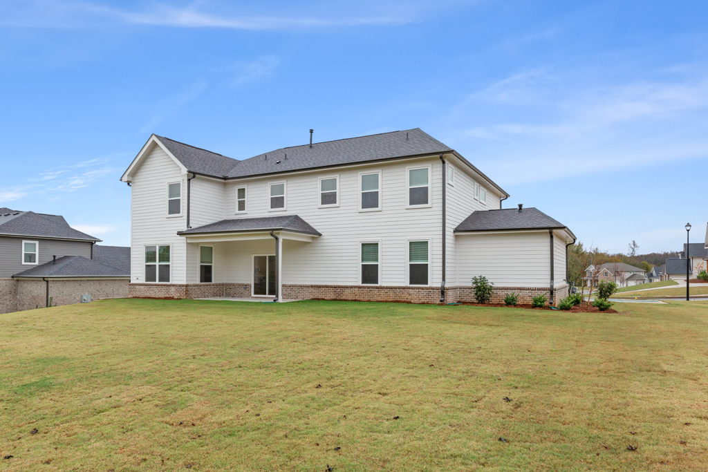 A house with a lawn in front of it.