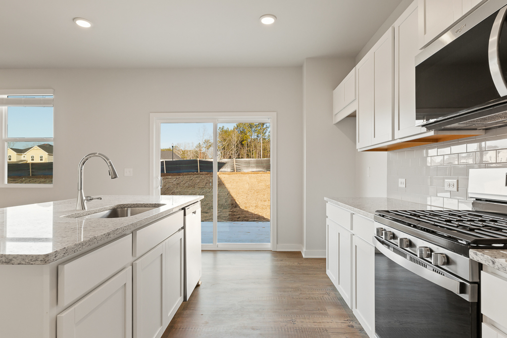 A kitchen with white cabinets.