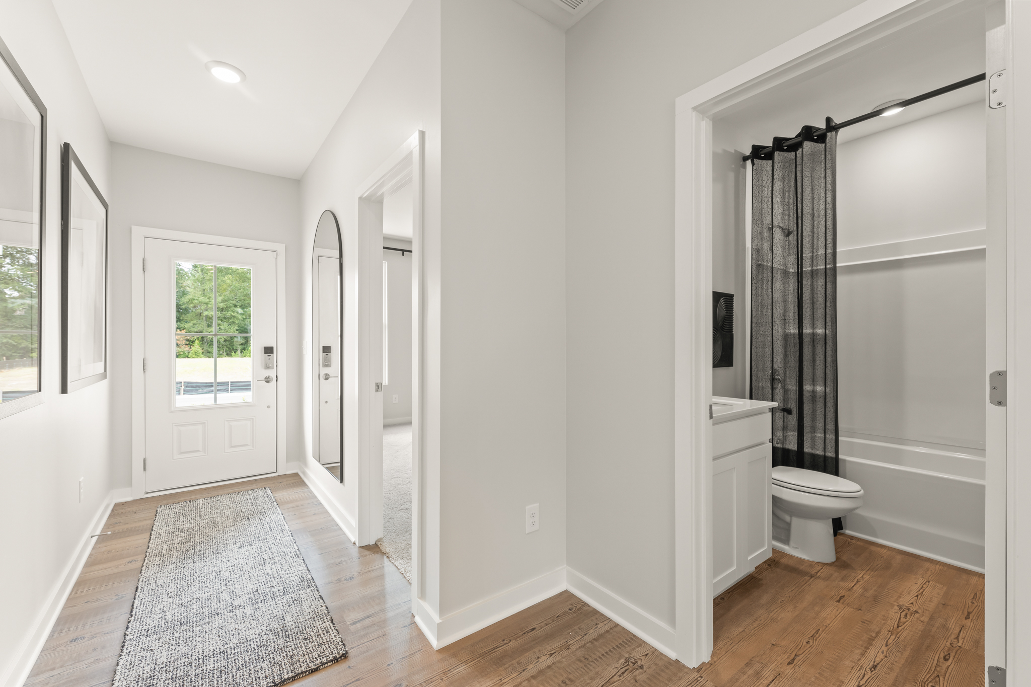 A bathroom with a shower and toilet.