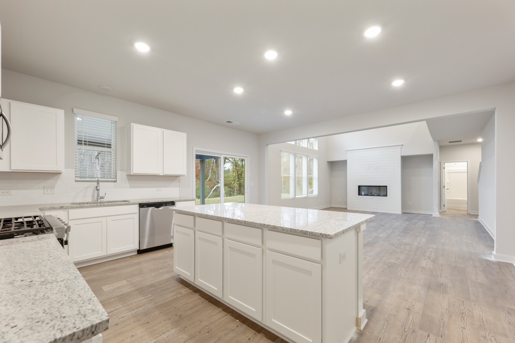 A kitchen with white cabinets.