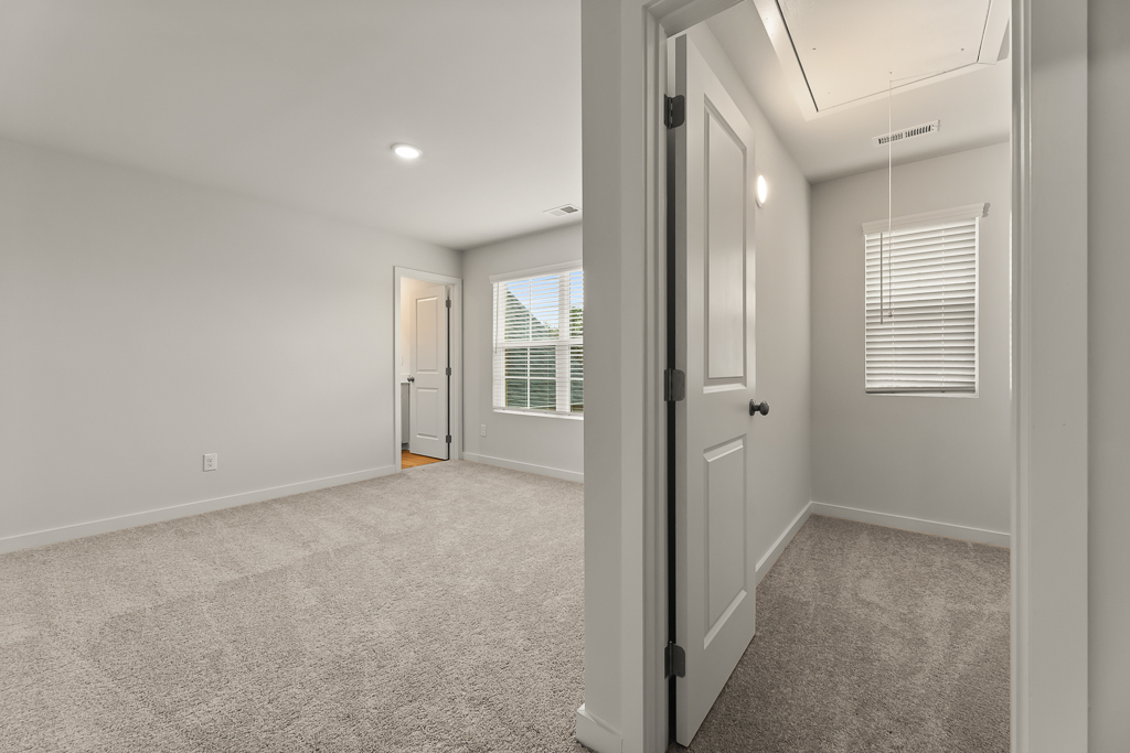 A hallway with white doors.