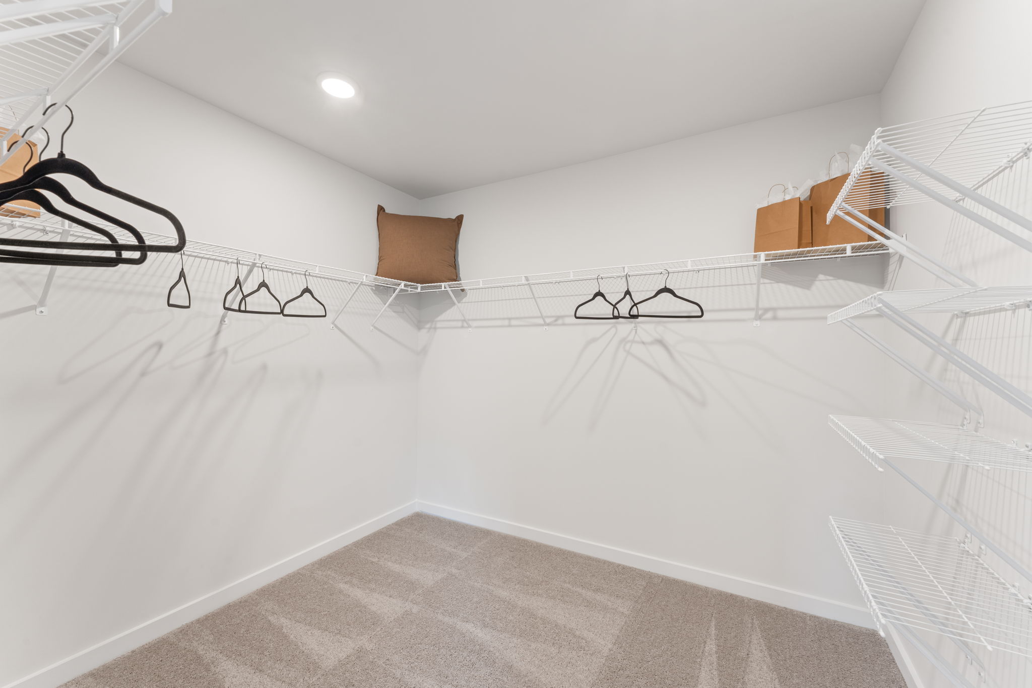 A white bed with a white bed frame.