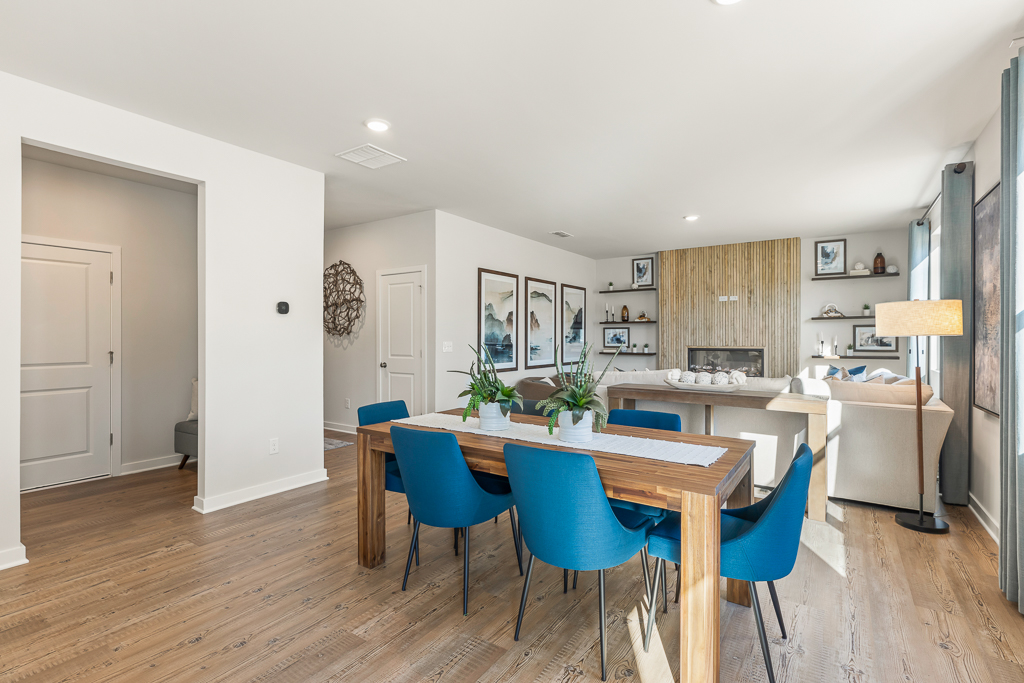 A dining room with a table and chairs.
