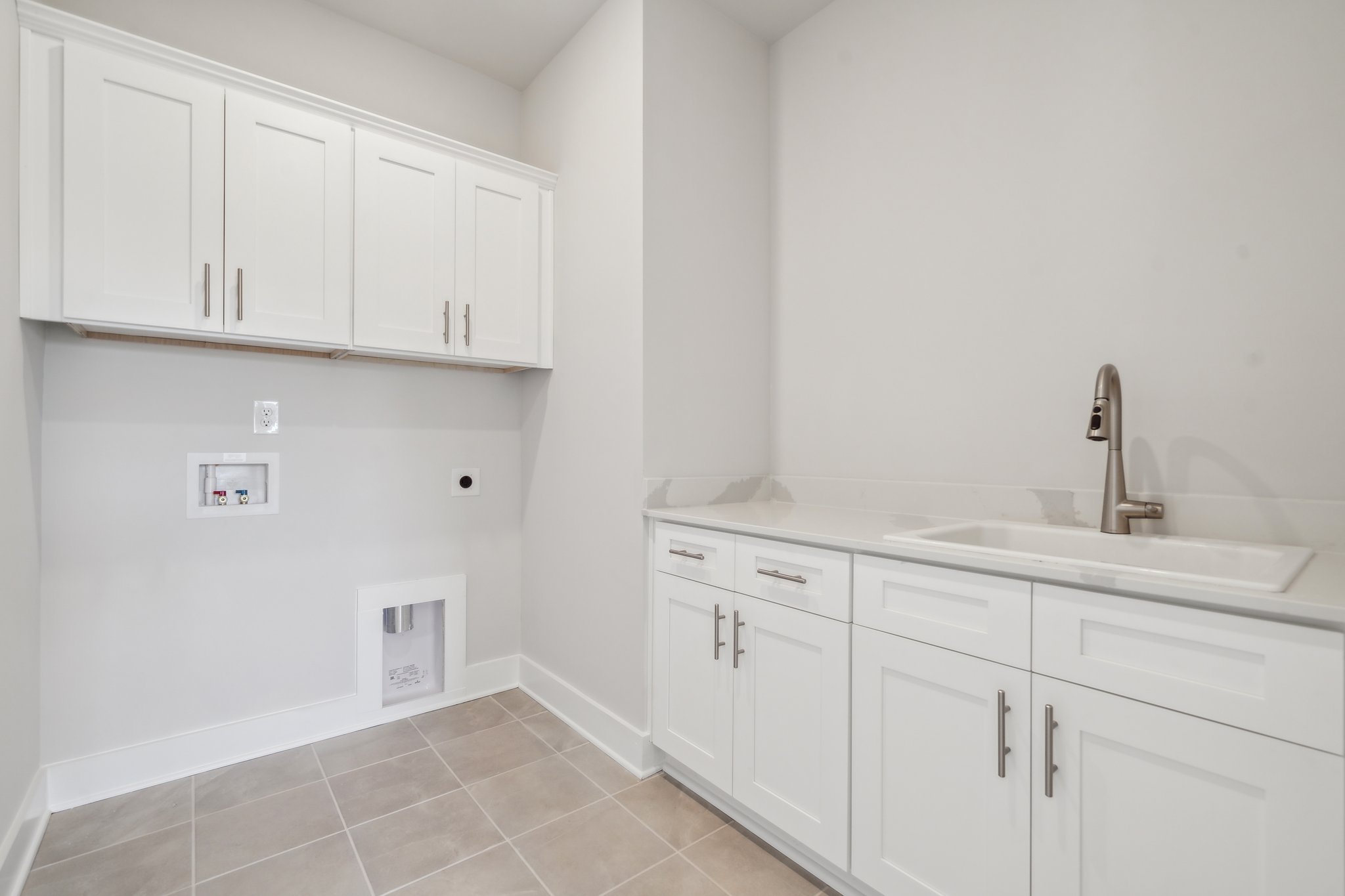 A white kitchen with white cabinets.
