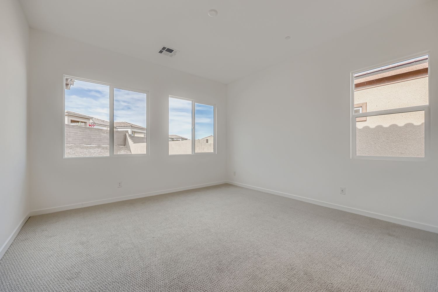 A room with a window and a view of the city.