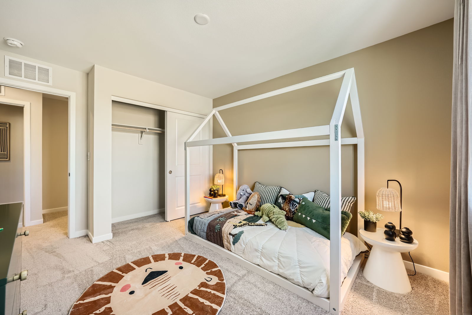 A bedroom with a bed and a rug.