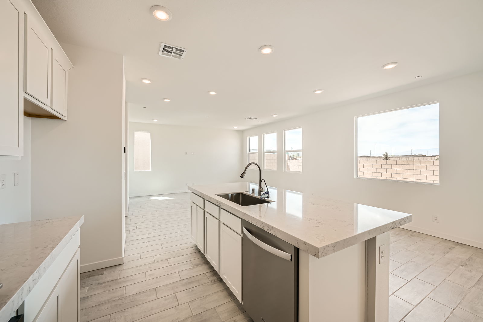 A kitchen with white cabinets.