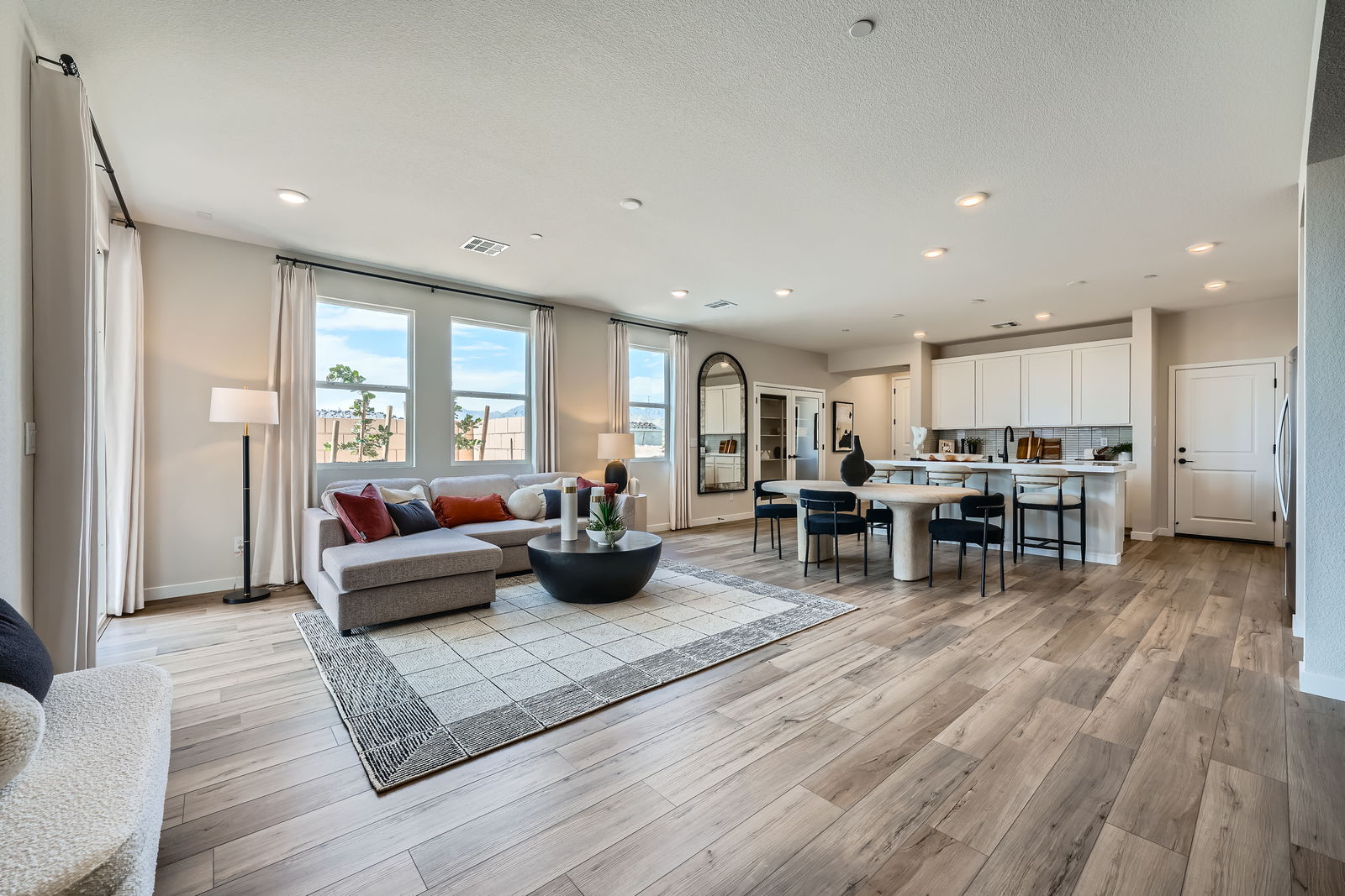 A large living room with a wood floor.