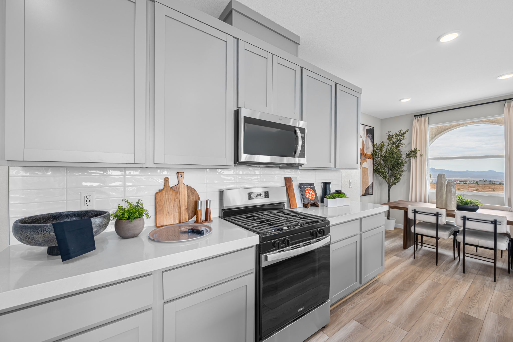 A kitchen with white cabinets.
