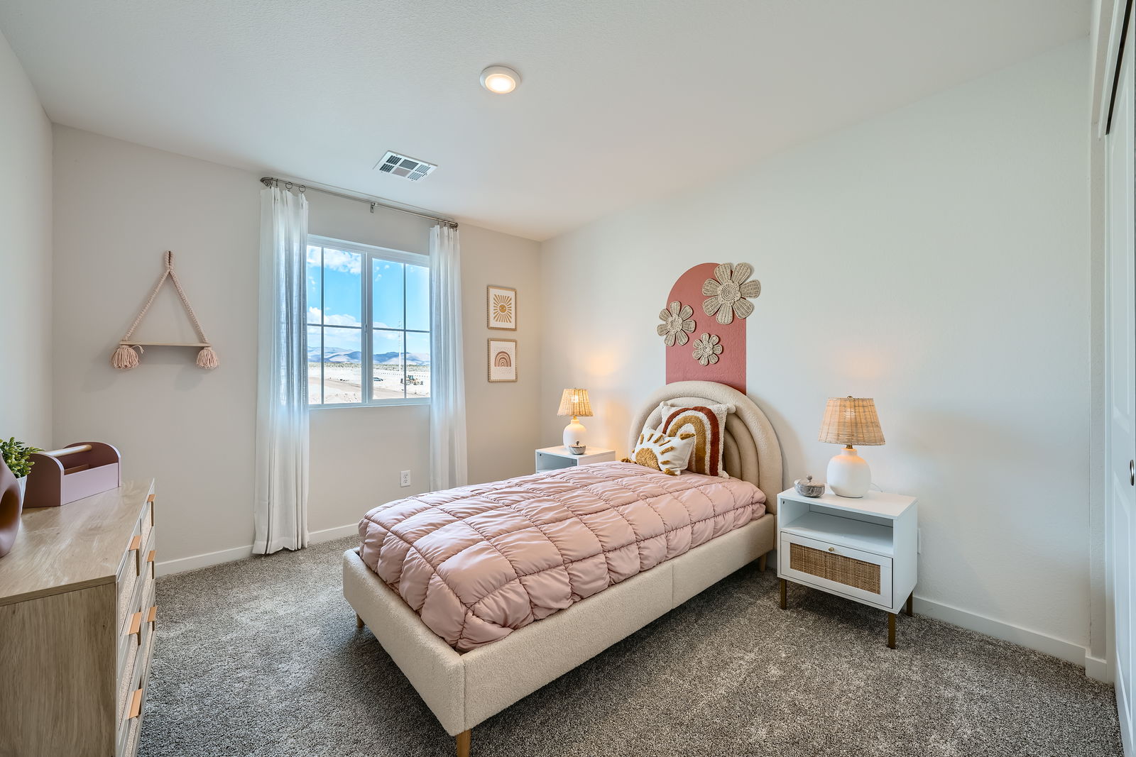 A bedroom with a bed and a window.