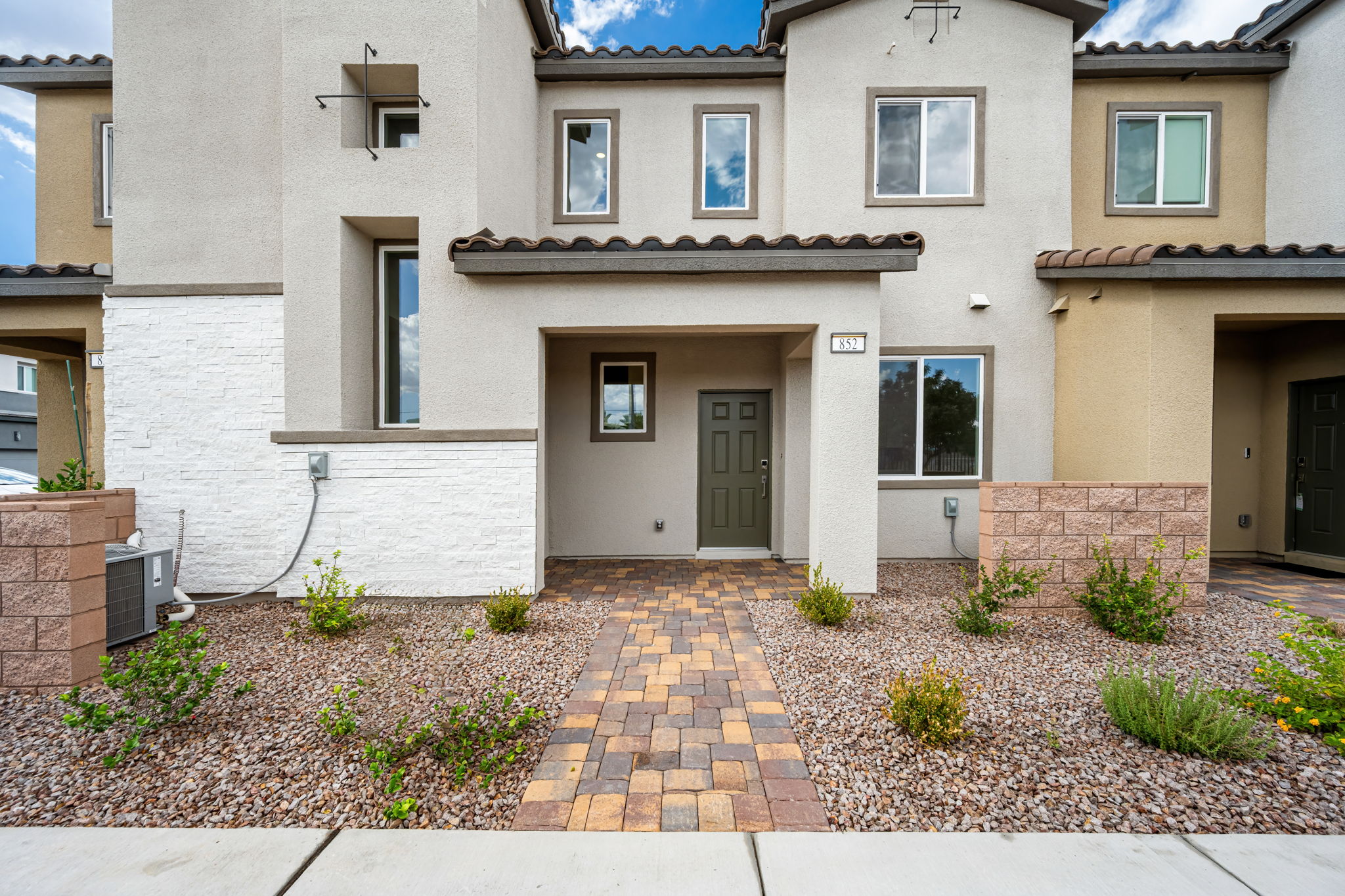 A building with a brick driveway.