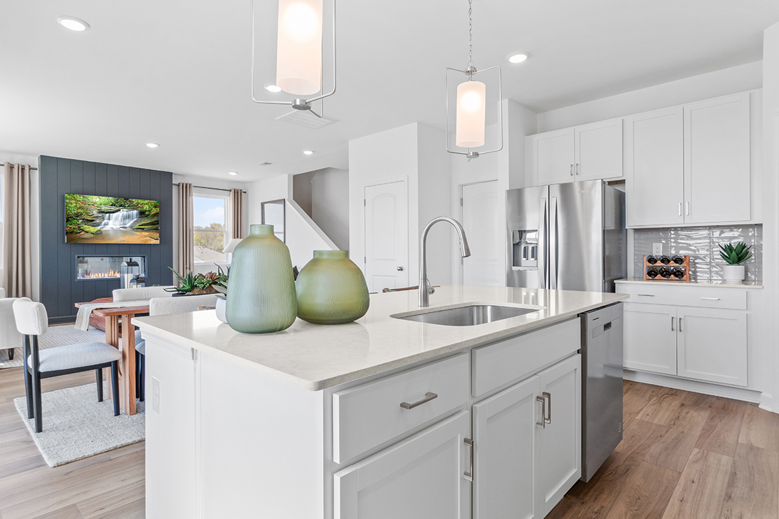 A kitchen with white cabinets.