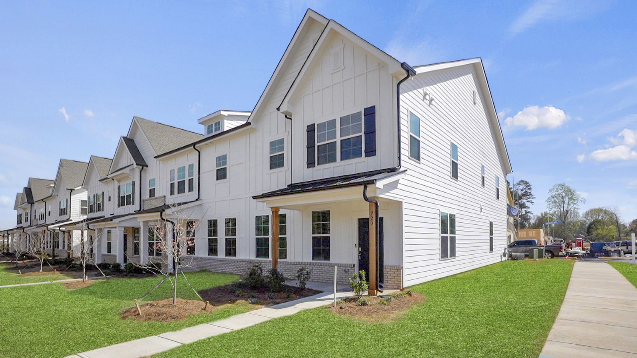 A white house with a lawn with Amelia Earhart Birthplace in the background.