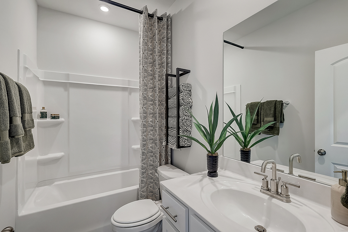 A bathroom with a sink and a shower.