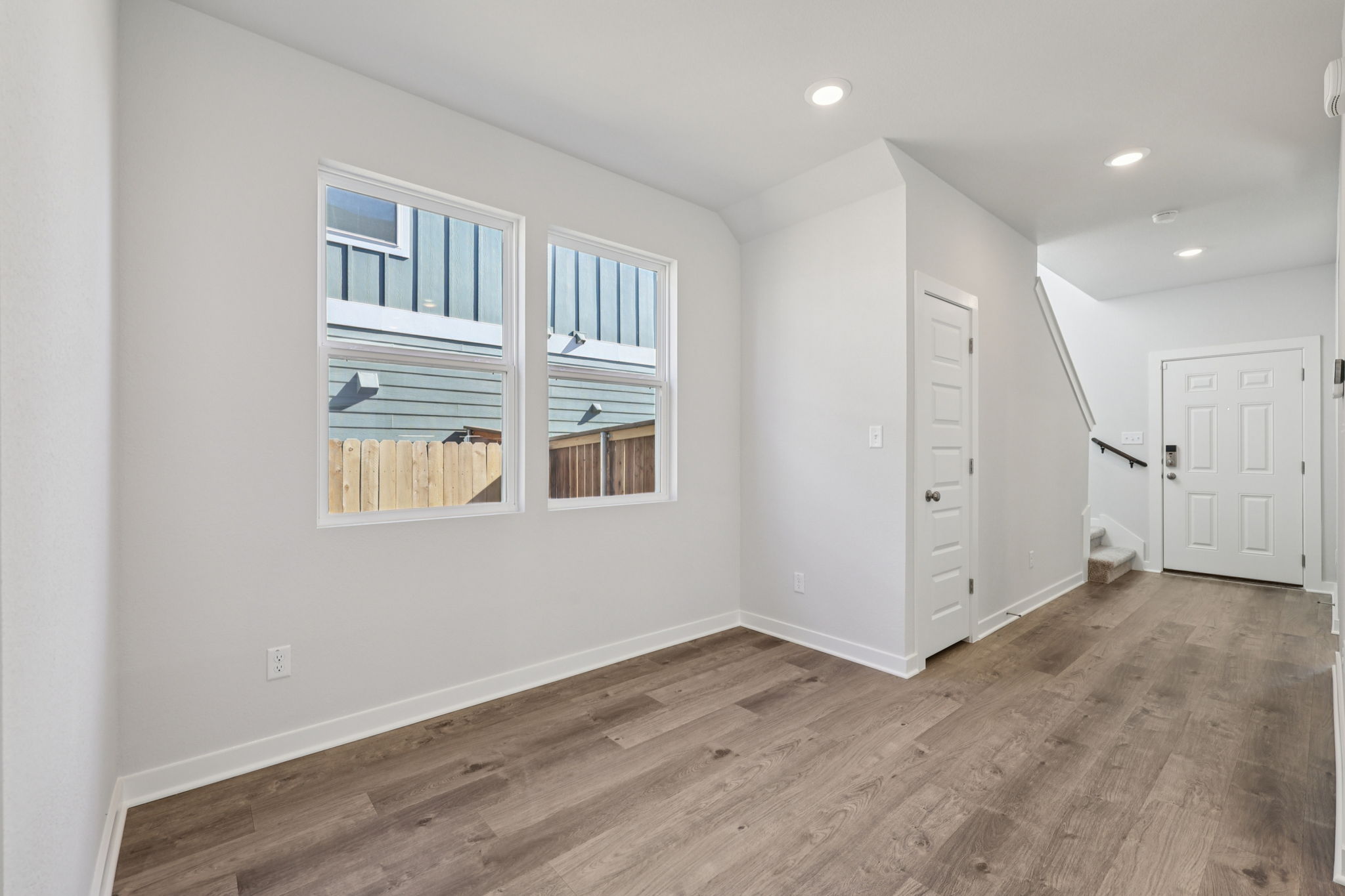 A room with white walls and a wood floor.
