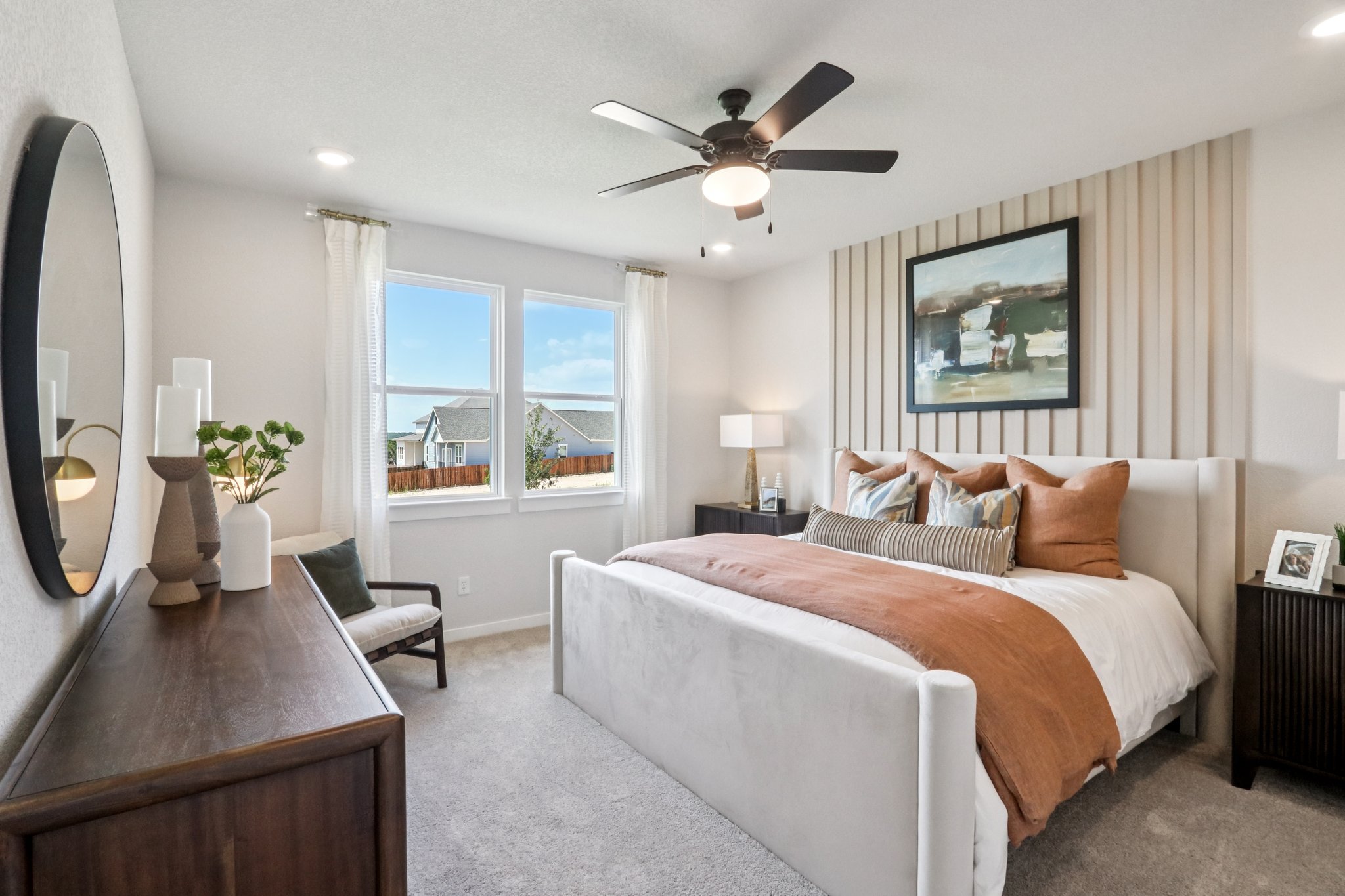 A bedroom with a large window.