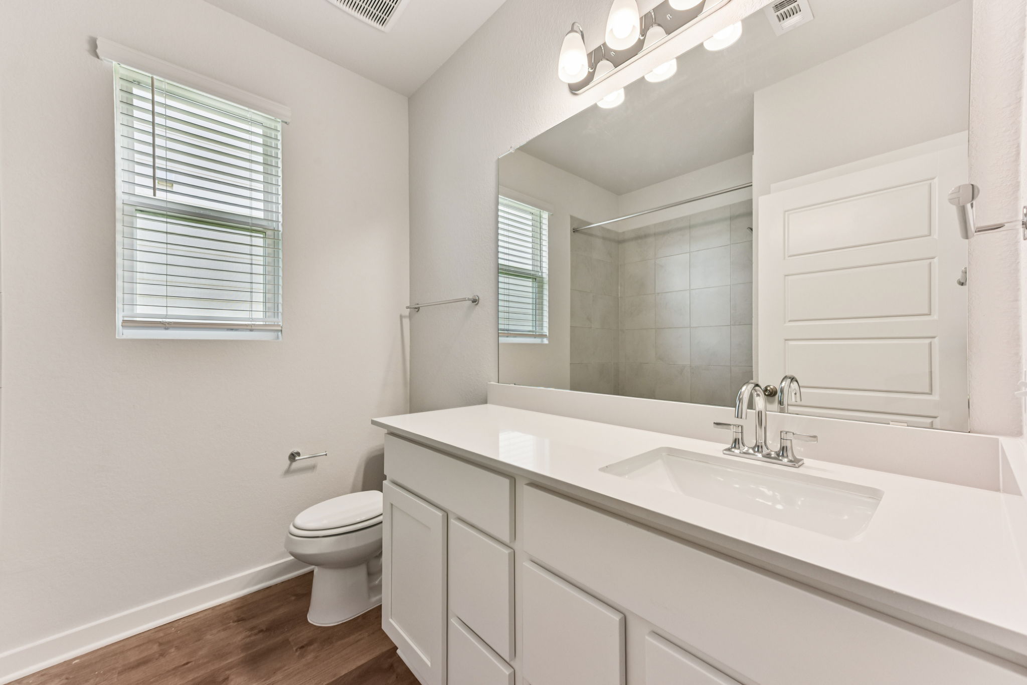 A bathroom with a large mirror.