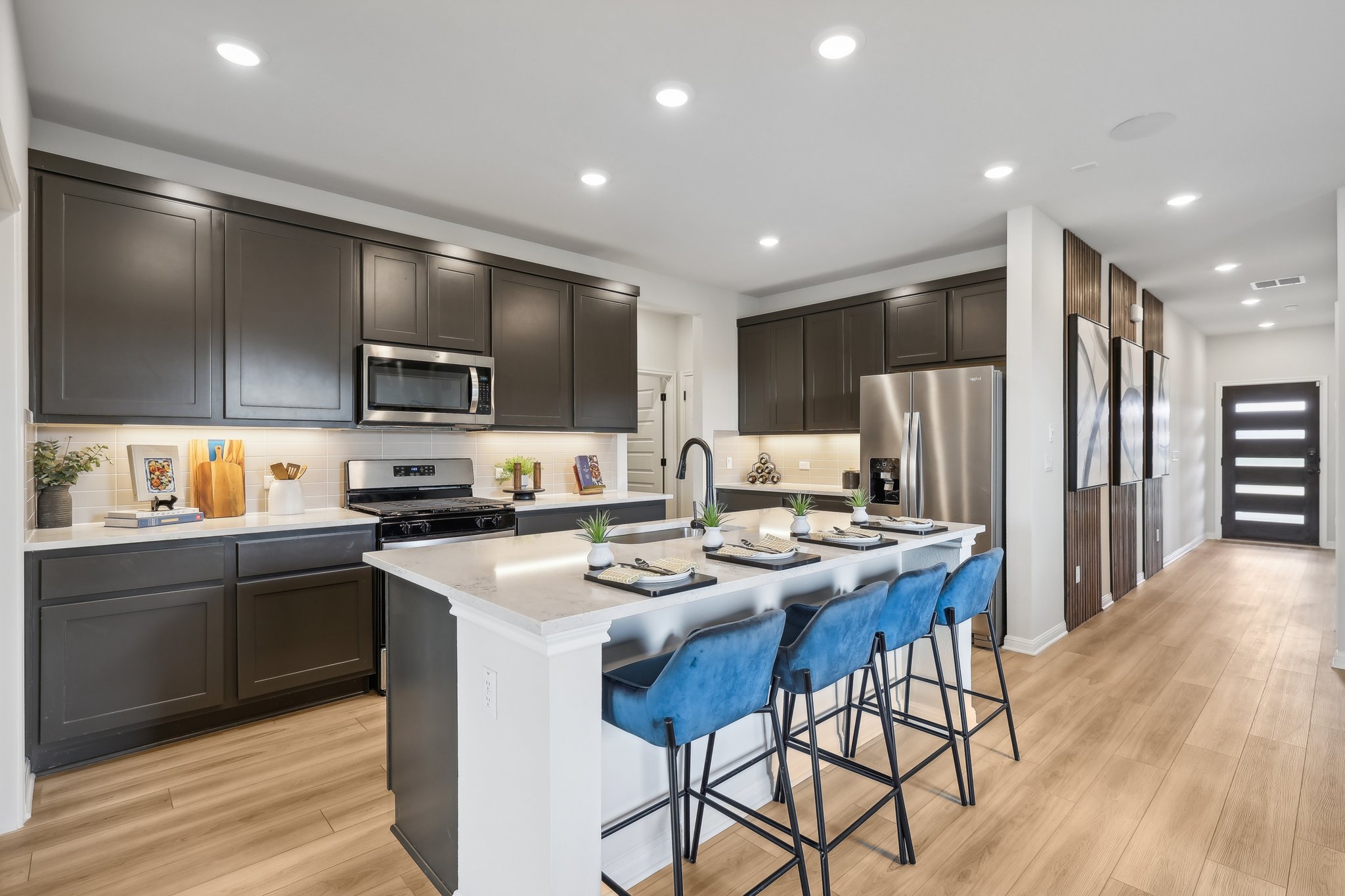 A kitchen with black cabinets.
