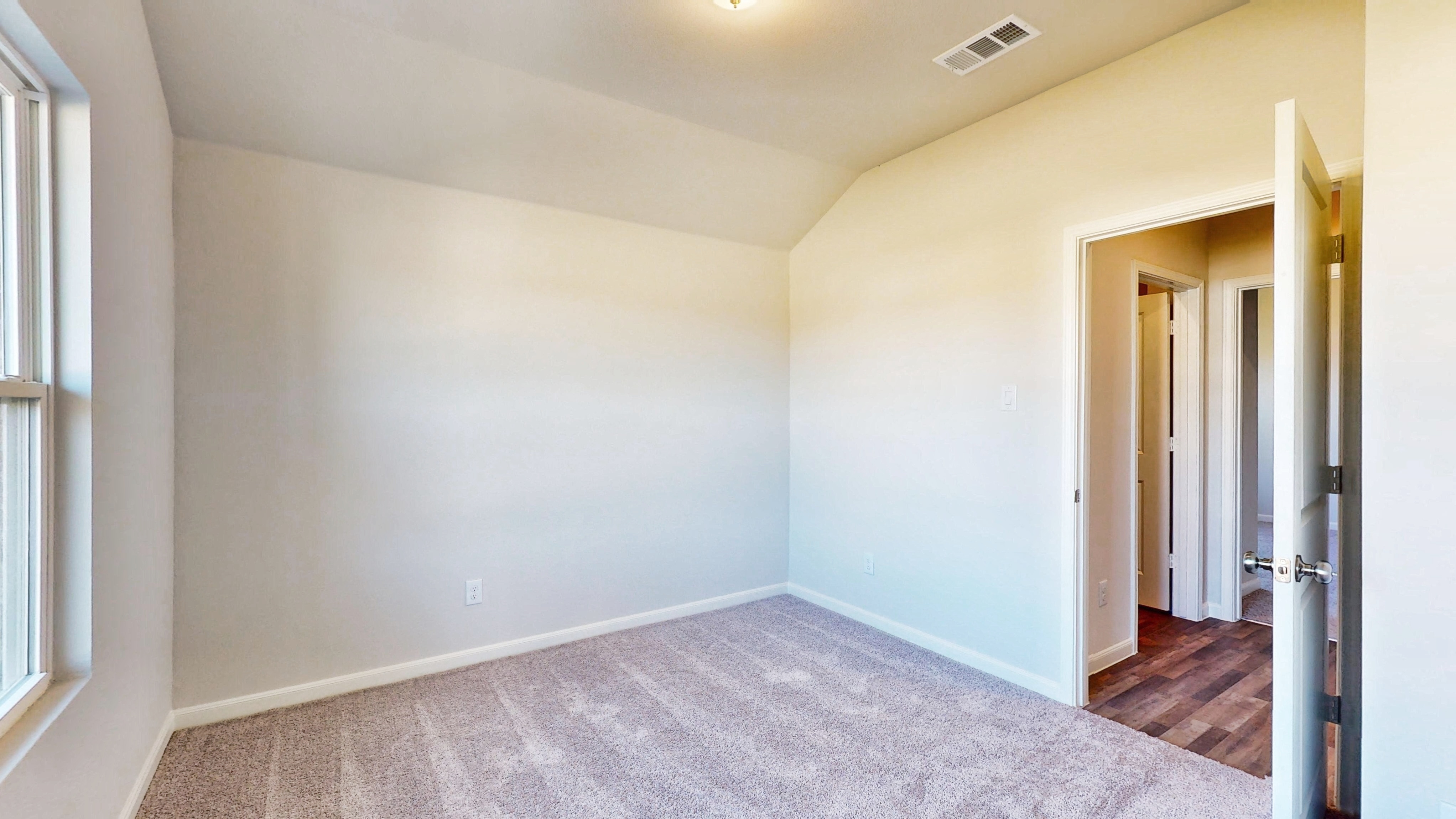 A hallway with white walls.