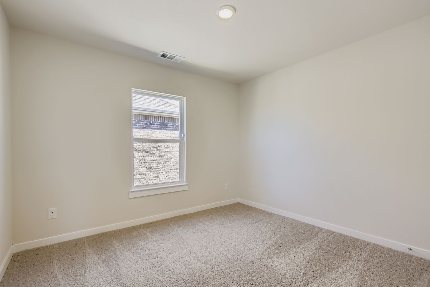 A room with a window and carpet.