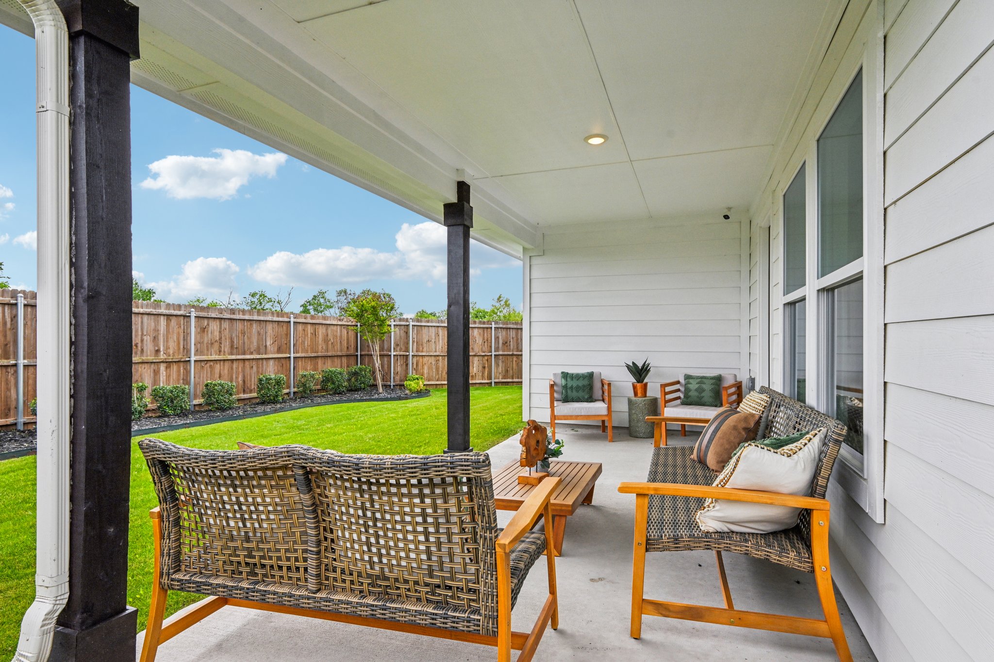 A patio with a table and chairs.