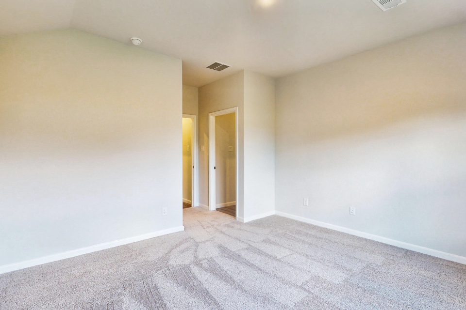 A hallway with a carpet.