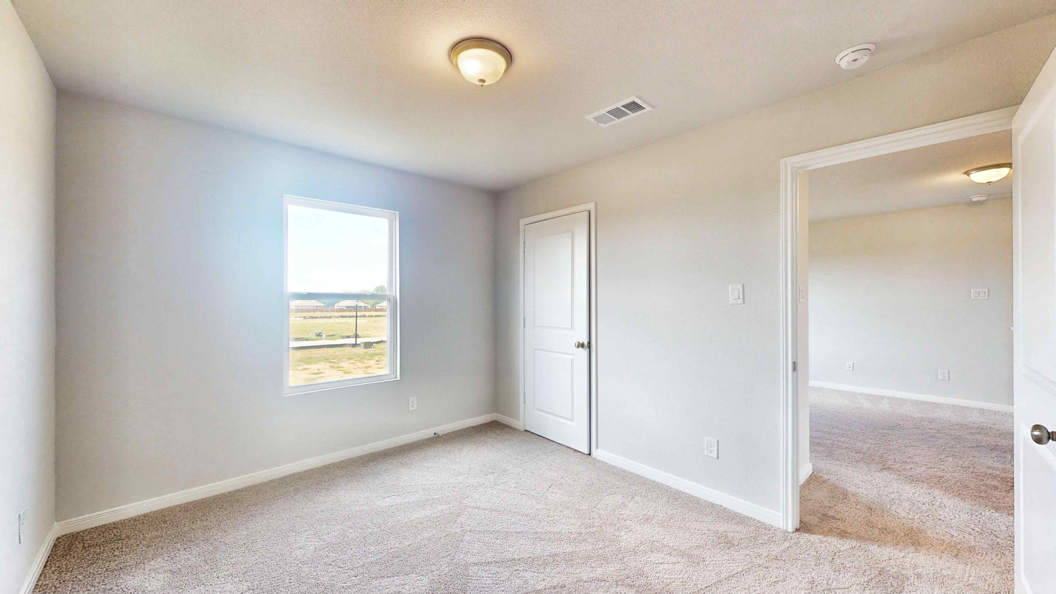 A room with a window and a door.