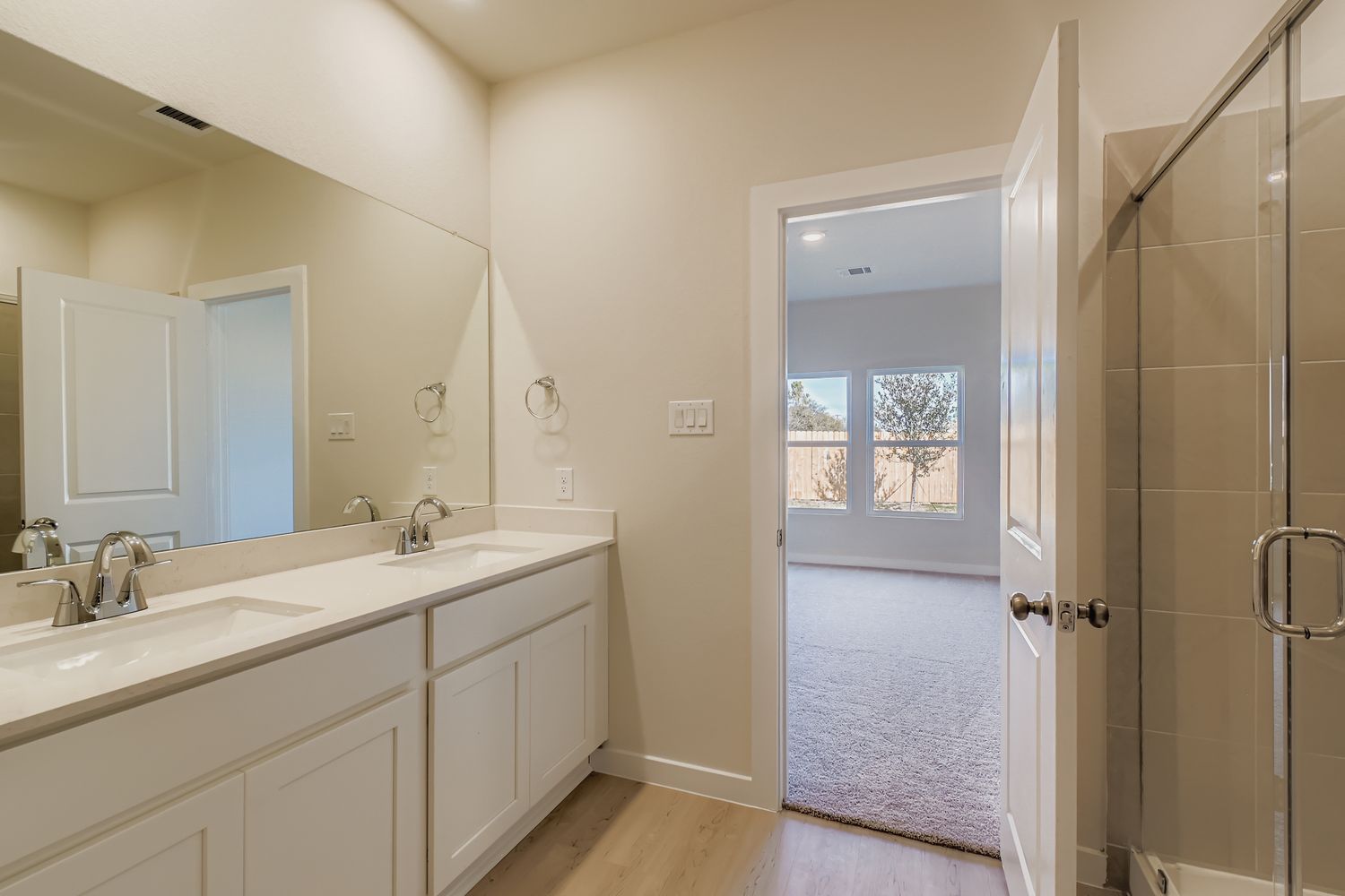 A bathroom with a glass door.