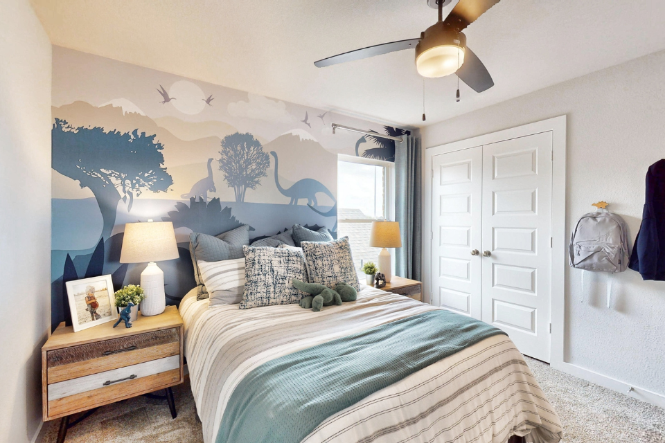 A bedroom with a bed and a fan.