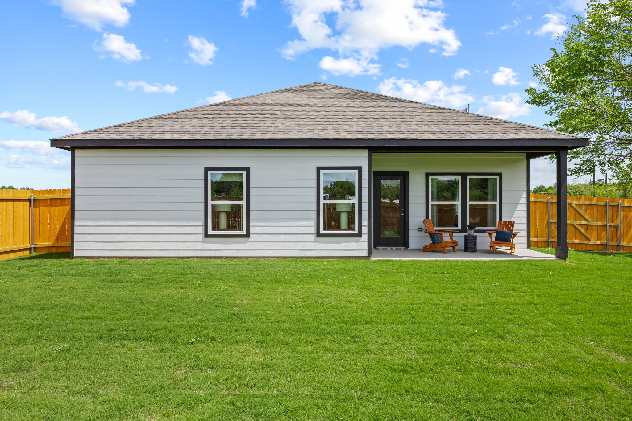 A house with a lawn in front.