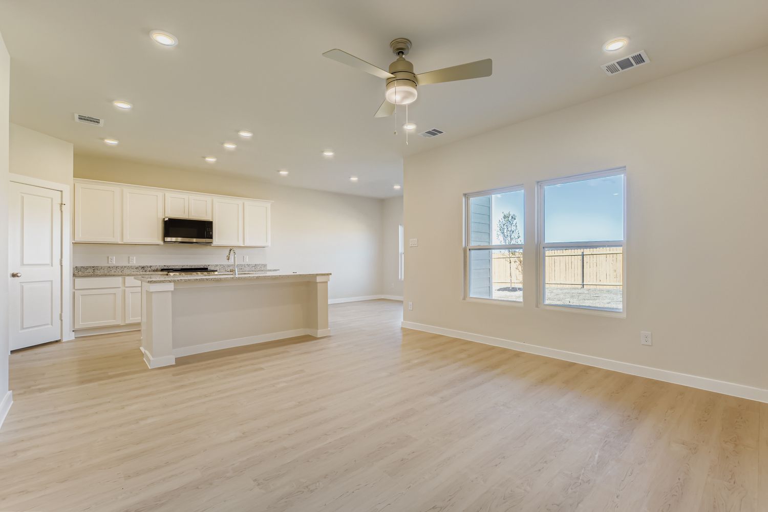 A large kitchen with white cabinets.