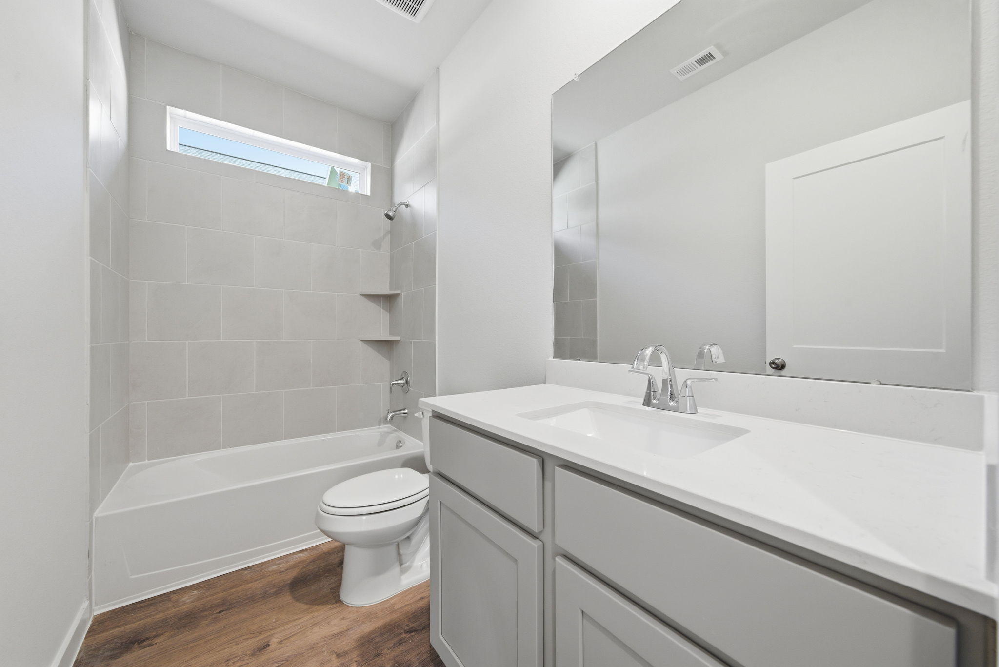 A bathroom with a tub sink and toilet.