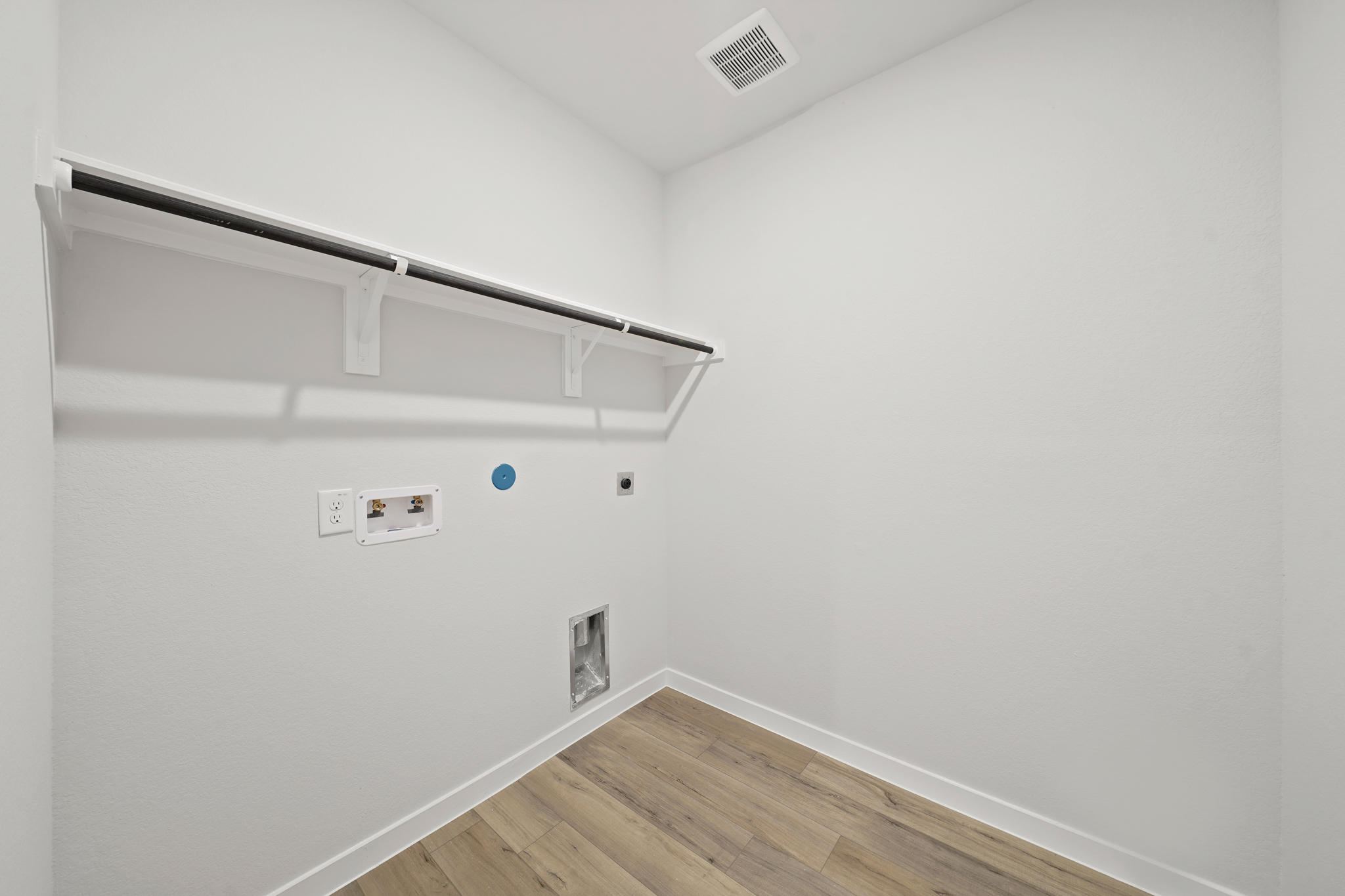 A white room with a wood floor.