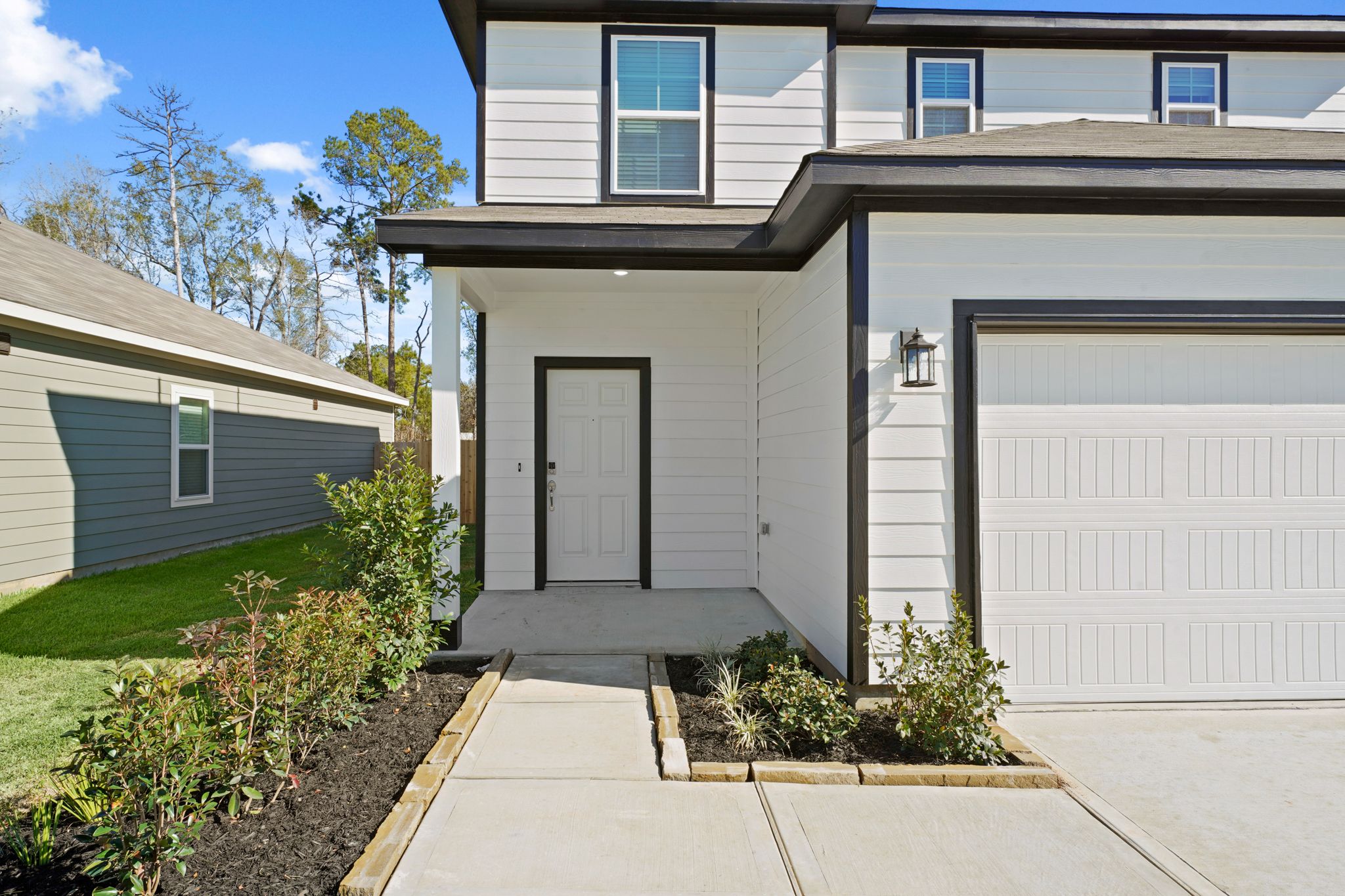 A house with garages and a driveway.