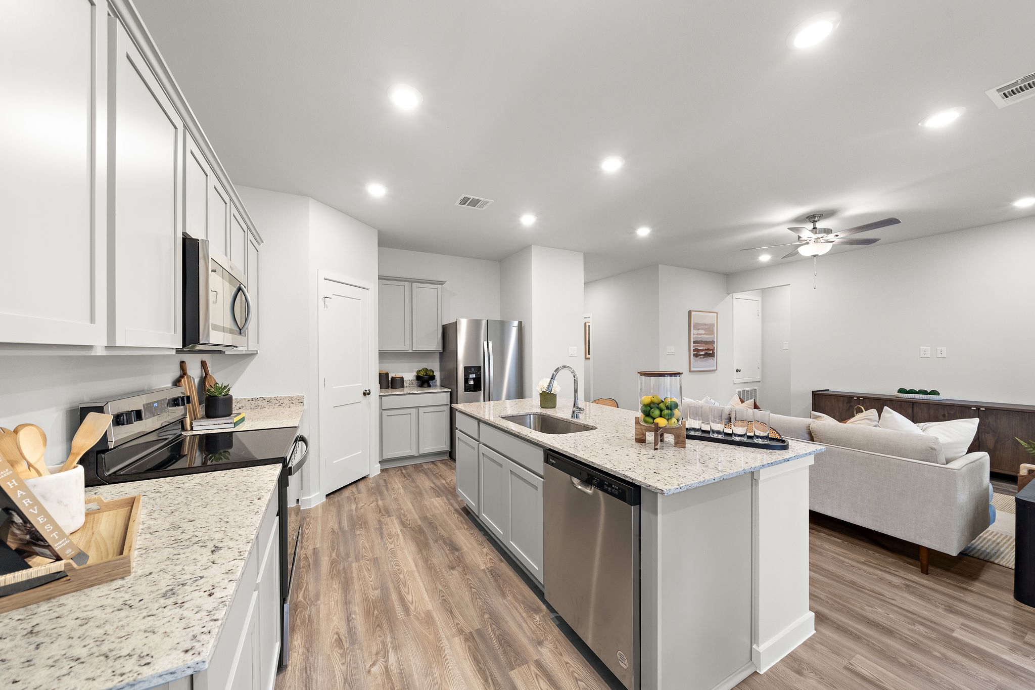 A kitchen with white cabinets.