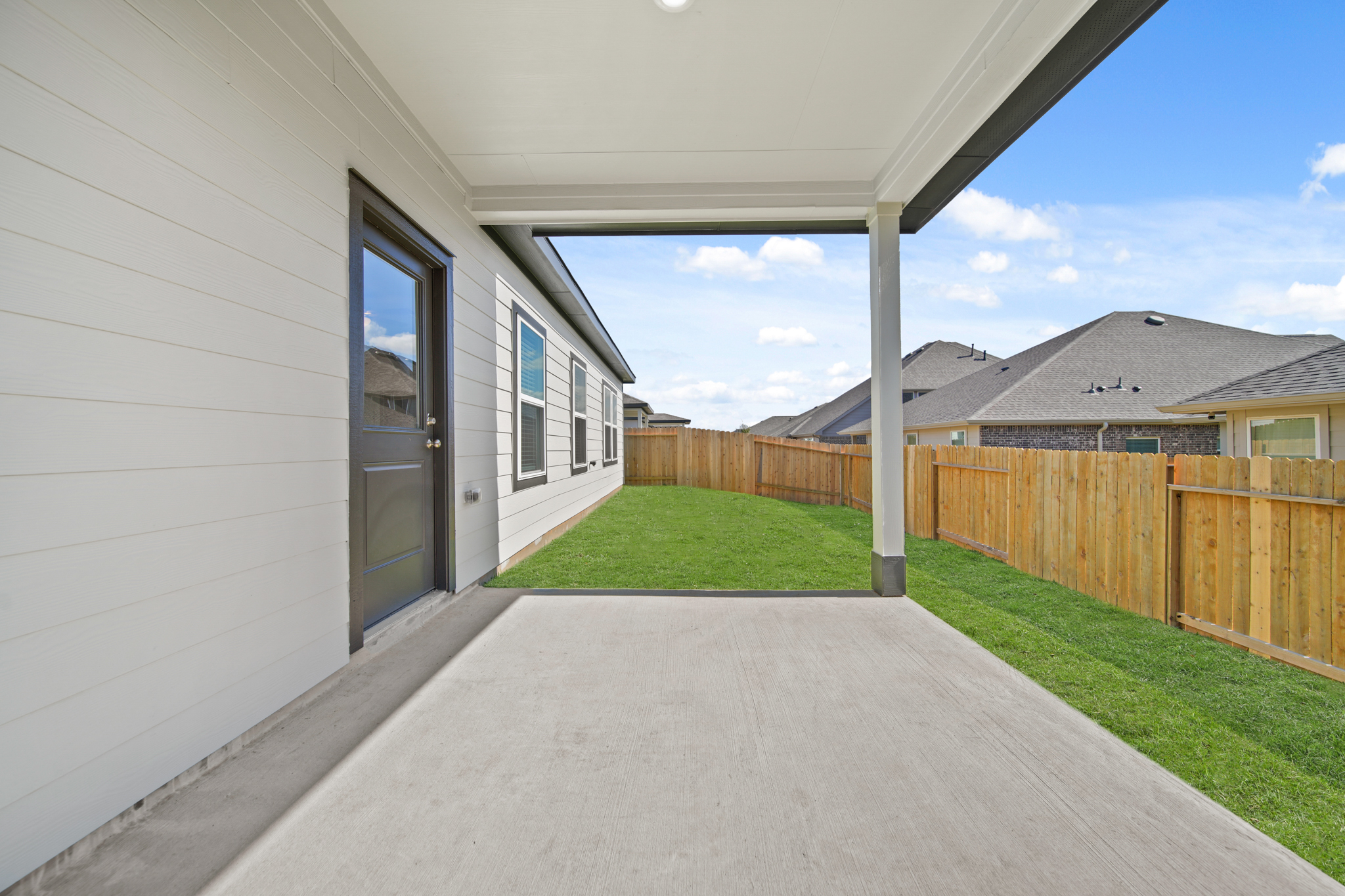 A house with a fence and grass.