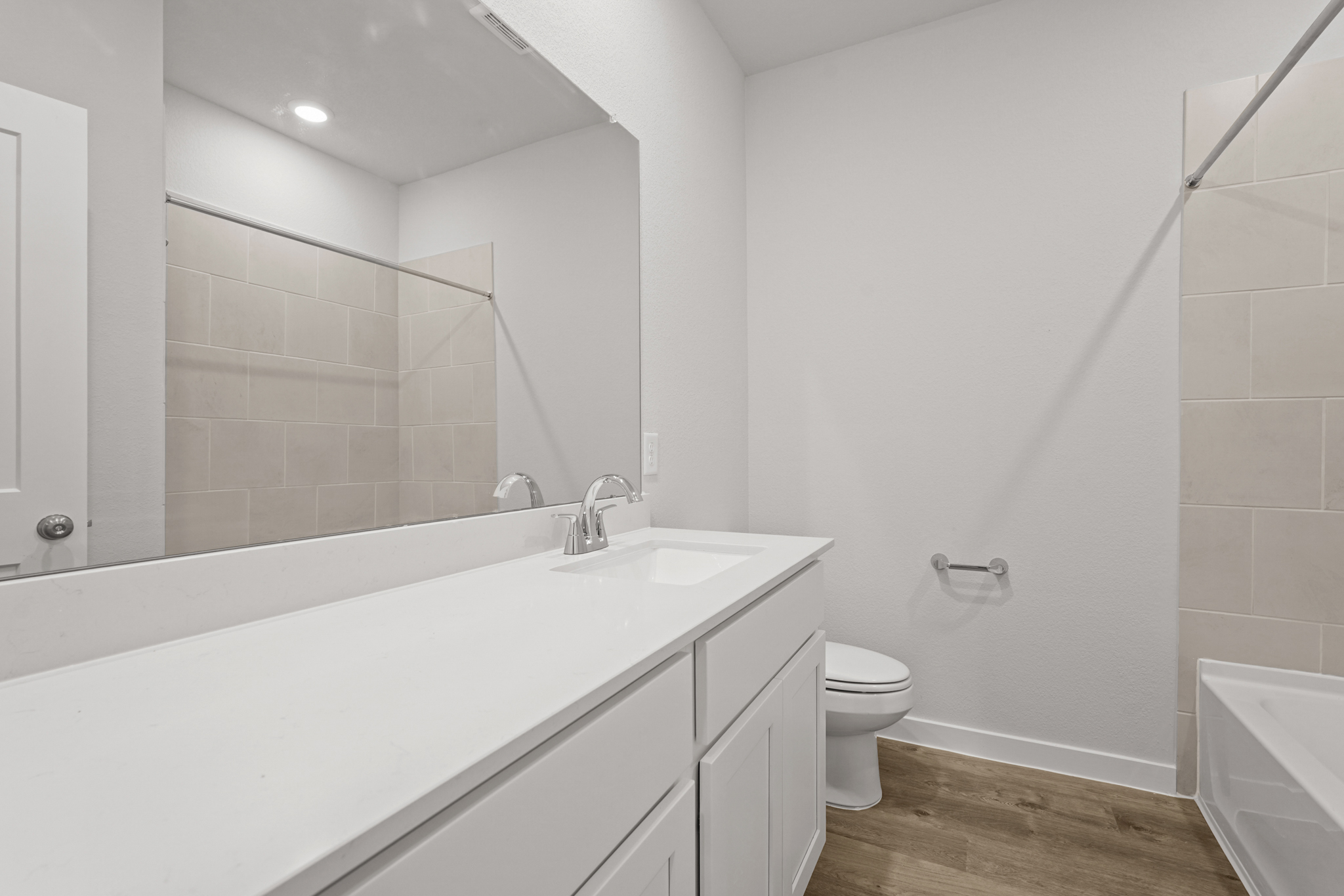 A bathroom with a tub toilet and sink.