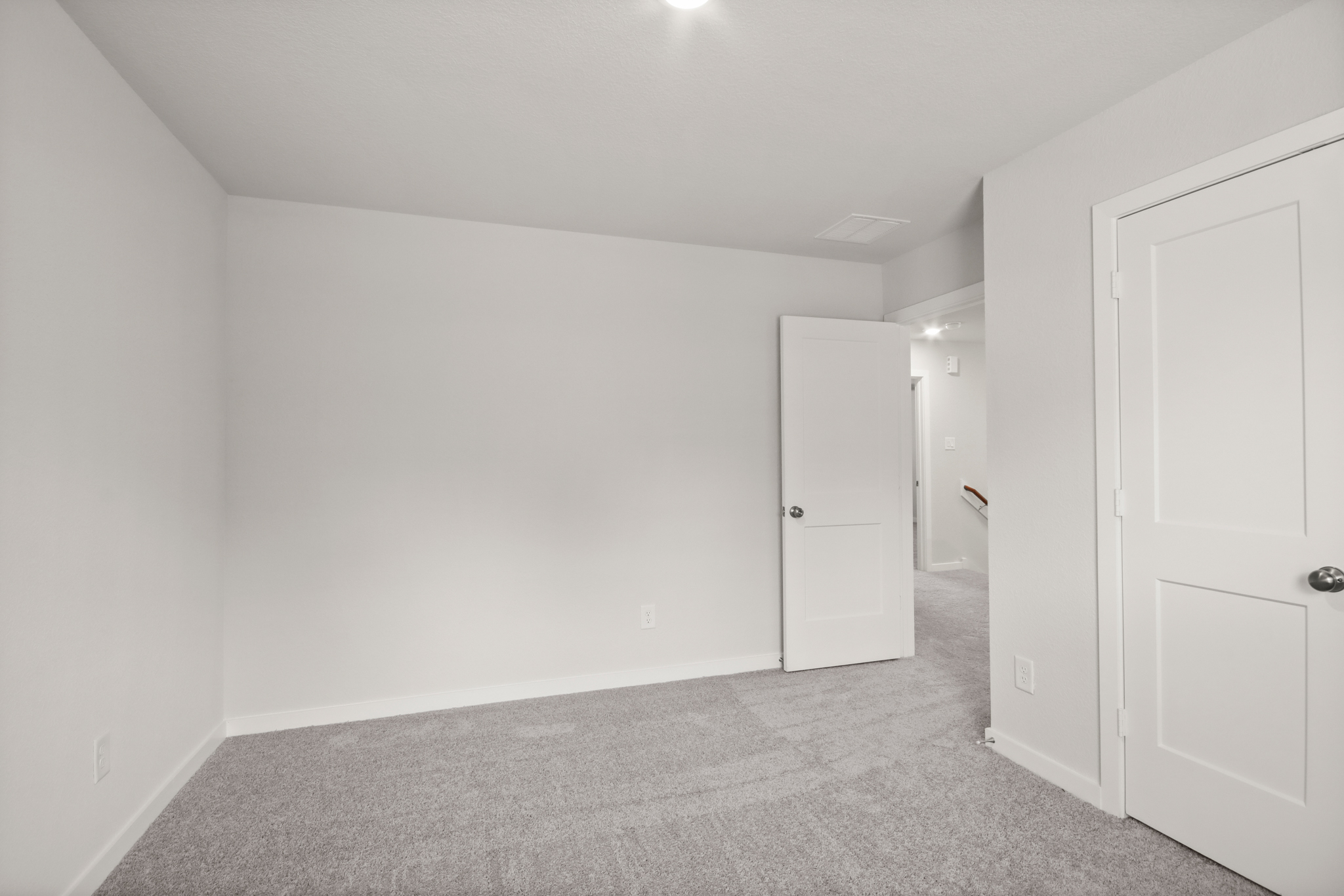 A hallway with white doors.