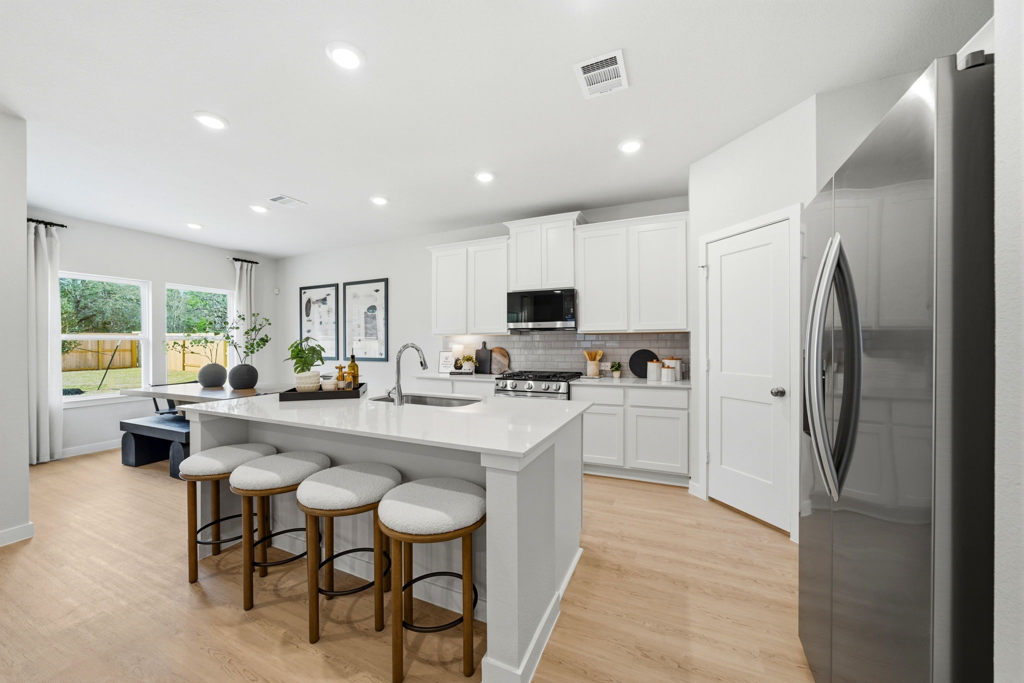 A kitchen with white cabinets.