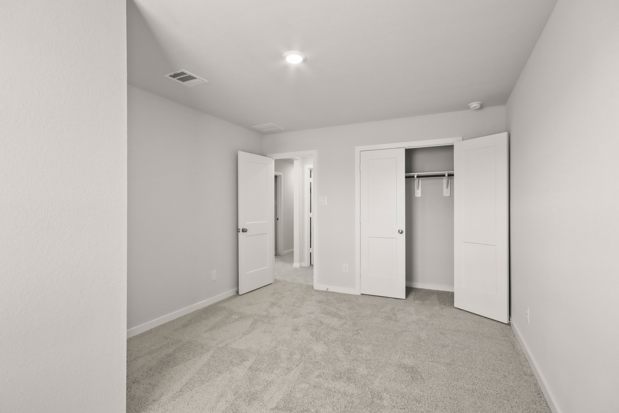 A hallway with white doors.