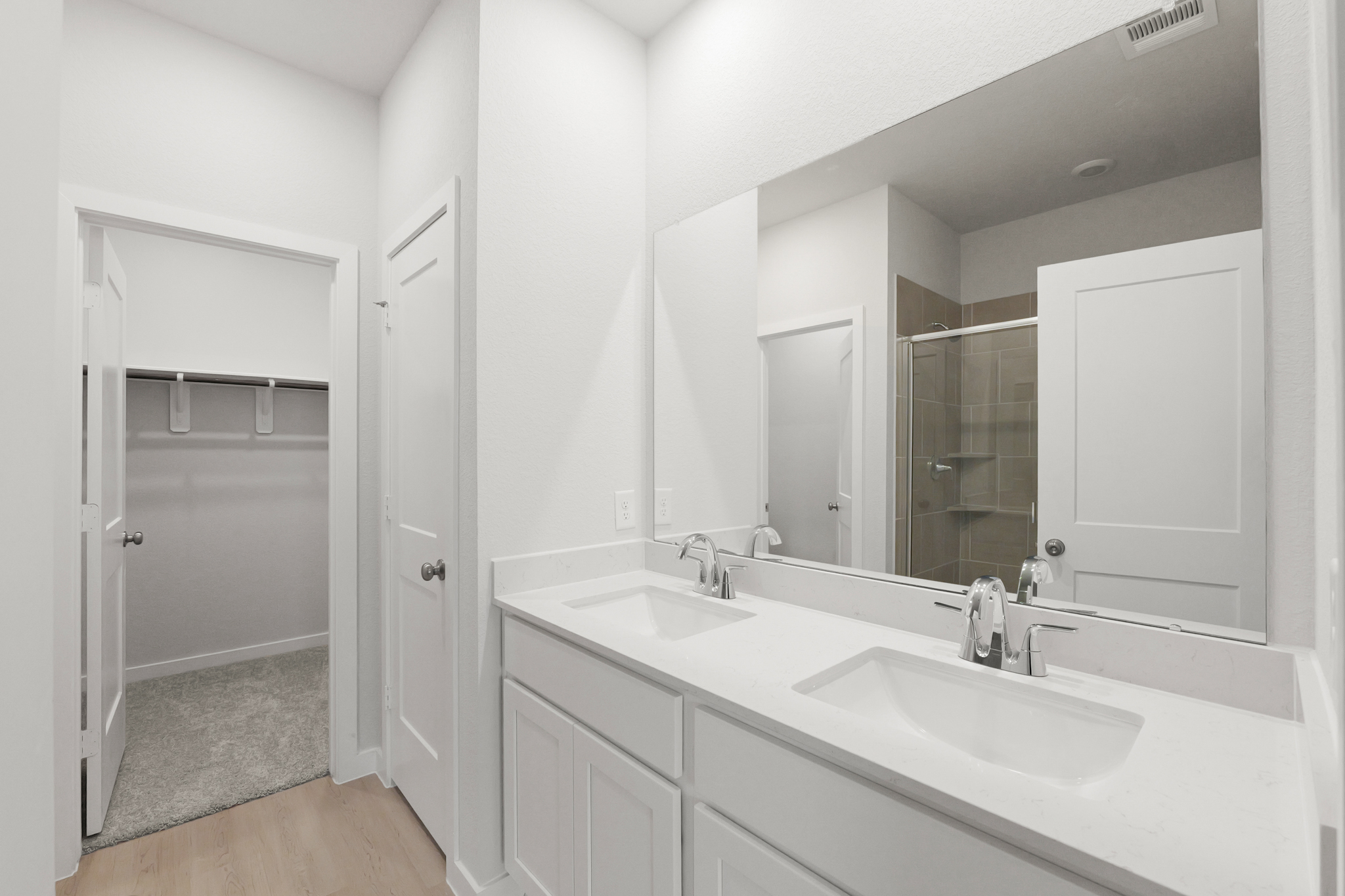 A bathroom with a large mirror.