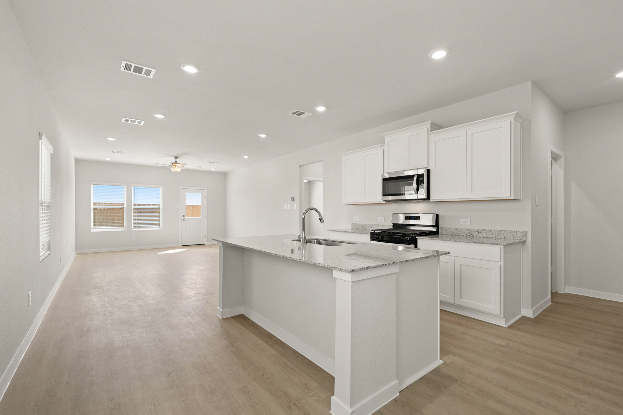 A kitchen with white cabinets.