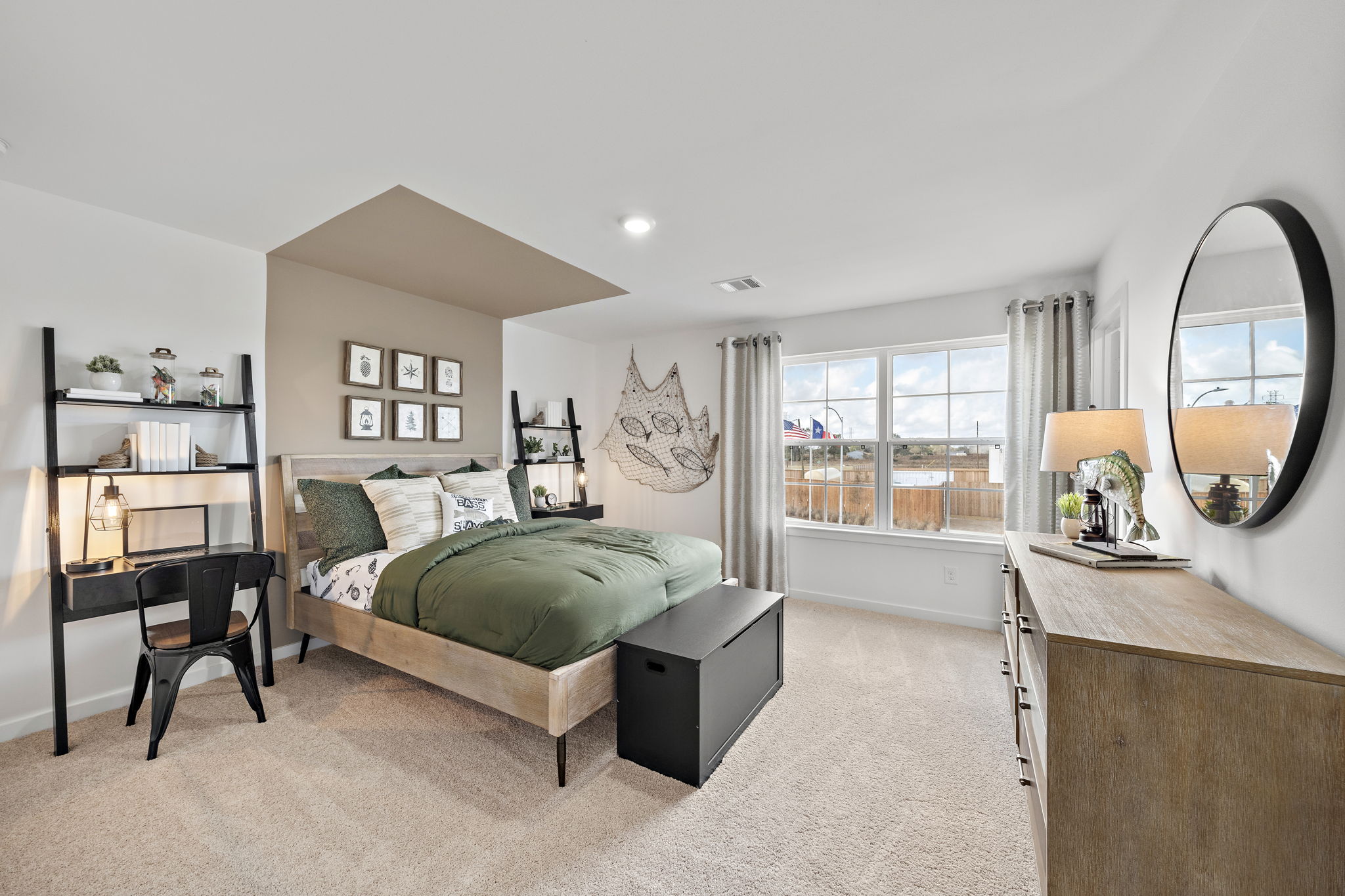 A bedroom with a large mirror.